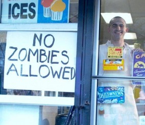 No zombies allowed sign on a liquor store door.